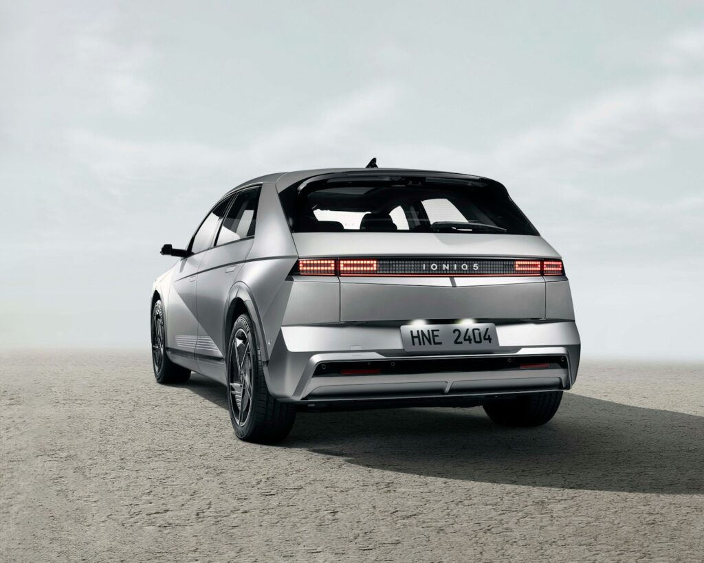 the rear end of a silver car in a desert