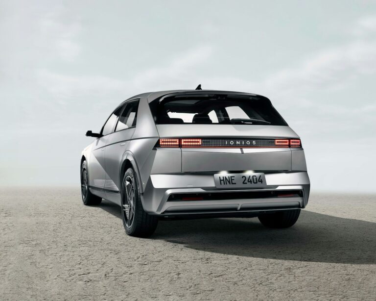 the rear end of a silver car in a desert